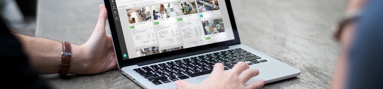 checking-solink-on-laptop A person is using a laptop with a picture on it.