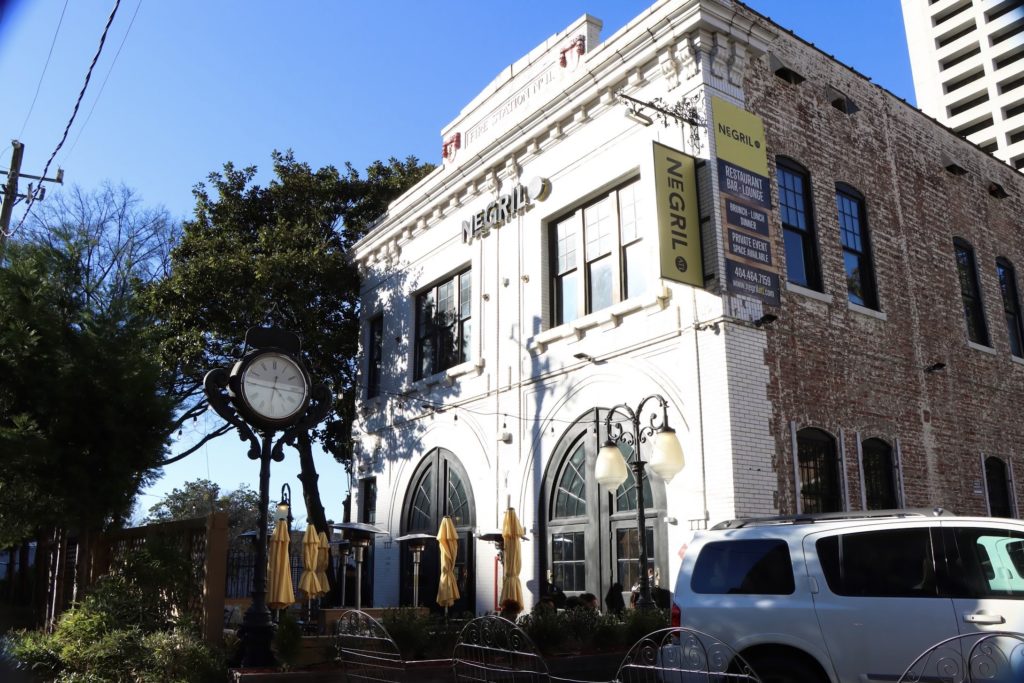 A white van is parked in front of a building.