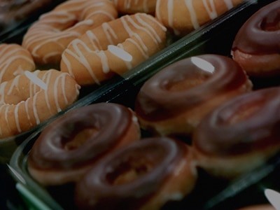 Many boxes of donuts are on display in a store, including Lesley Holmes' specialty selection.