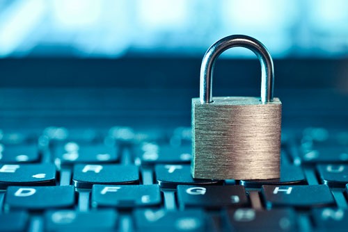A padlock sits on top of a keyboard.