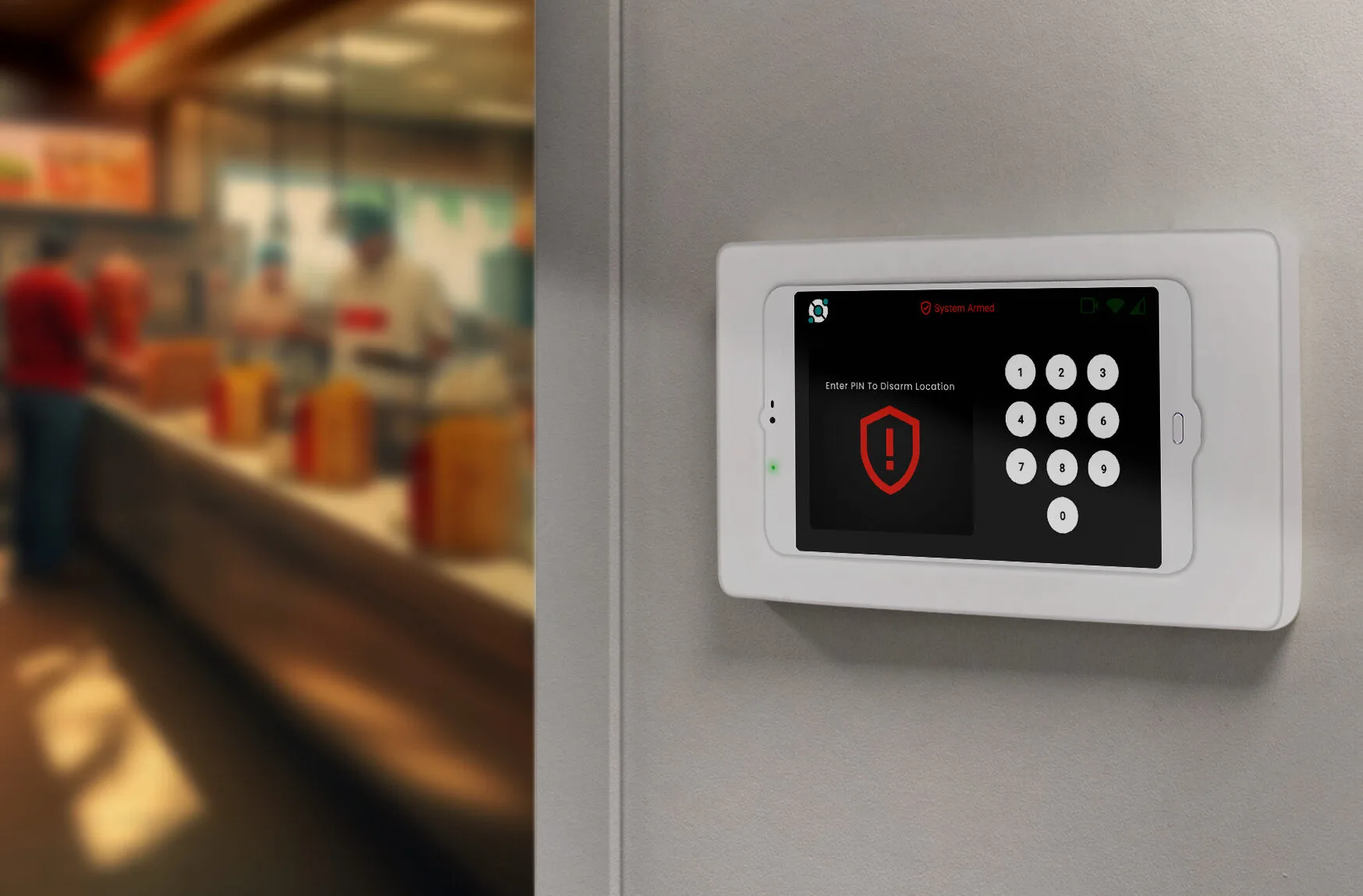 A security keypad on a wall displays a warning alert and requires a PIN for access in a commercial setting. People are seen in a blurred background.
